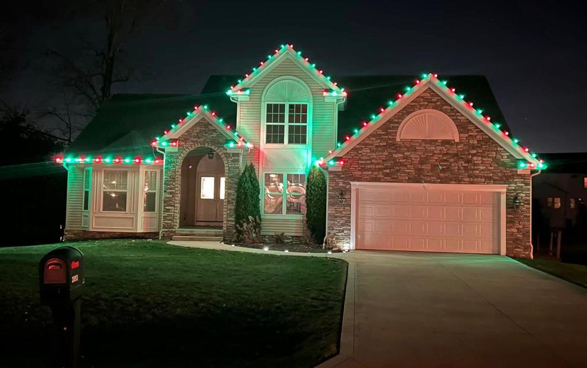 Home with red and green roofline lights